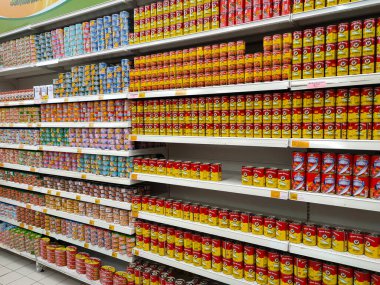 SELANGOR, MALAYSIA -JULY 6, 2022: Selective focused on sardine fish can. The fish has been processed, cook and packed in the can. Displayed on the rack for sale and tag with the price tag