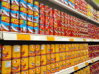 SELANGOR, MALAYSIA -JULY 6, 2022: Selective focused on sardine fish can. The fish has been processed, cook and packed in the can. Displayed on the rack for sale and tag with the price tag
