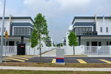 SELANGOR, MALAYSIA - JUNE 18, 2022: New double-story terrace house under construction in Malaysia. This house has a wide front porch and is fenced. Has basic facilities.