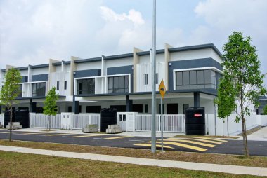 SELANGOR, MALAYSIA - JUNE 18, 2022: New double-story terrace house under construction in Malaysia. This house has a wide front porch and is fenced. Has basic facilities.