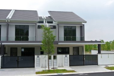 SELANGOR, MALAYSIA - JUNE 18, 2022: New double-story terrace house under construction in Malaysia. This house has a wide front porch and is fenced. Has basic facilities.