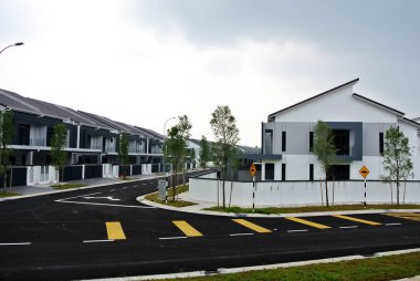 SELANGOR, MALAYSIA - JUNE 18, 2022: New double-story terrace house under construction in Malaysia. This house has a wide front porch and is fenced. Has basic facilities.