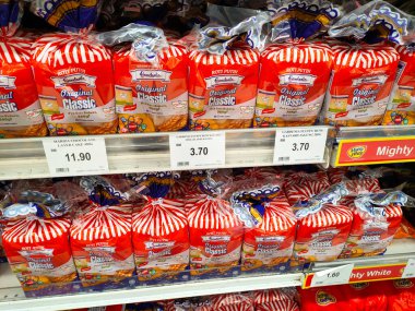 SEREMBAN, MALAYSIA -APRIL 28, 2020: Various types of bread in commercial packaging displayed on shelves for sale. Separated by type and brand to make it easier for customers to choose.