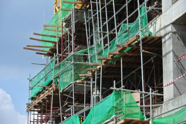 JOHOR, MALAYSIA -JULY 29, 2016: Scaffolding used as the temporary structure to support platform, form work and structure at the construction site. Also used it as a walking platform for workers. 