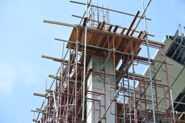 JOHOR, MALAYSIA -JULY 29, 2016: Scaffolding used as the temporary structure to support platform, form work and structure at the construction site. Also used it as a walking platform for workers. 