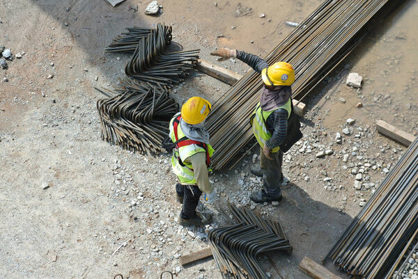 SELANGOR, MALAYSIA-AUGUST 05, 2016: Строители, работающие на заводе гибки арматуры на строительной площадке
.