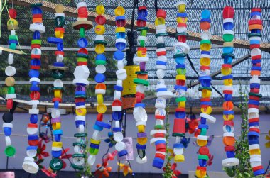 Bottle caps made of plastic combined and hanged.