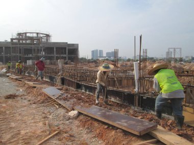 JOHOR, MALAYSIA -APRIL 06, 2016: Ground beam timber form work constructed by workers at the construction site. 