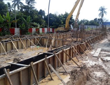 JOHOR, MALAYSIA -APRIL 06, 2016: Ground beam timber form work constructed by workers at the construction site. 