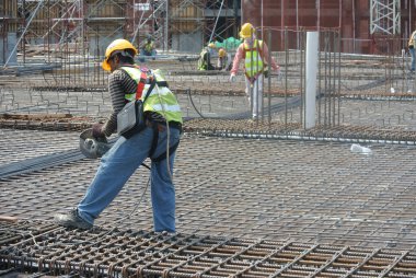 MALACCA, MALAYSIA -AUGUST 24, 2016: Construction workers fabricating floor slab reinforcement bar at the construction site in Malacca, Malaysia.  