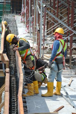 MALACCA, MALAYSIA -MAY 25, 2016: Construction workers fabricating timber form work at the construction site in Malacca, Malaysia. The form work was mainly made from timber and plywood. 