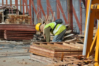 MELAKA, MALAYSIA -MAY 25, 2016: Construction workers fabricating timber form work at the construction site in Malacca, Malaysia. The form work was mainly made from timber and plywood. 