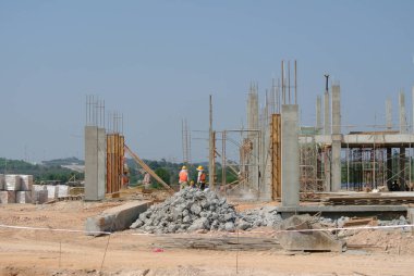 MALACCA, MALAYSIA -JUNE 13, 2016: Construction site in progress at Malacca, Malaysia during daytime. Workers busy with their task such as installing form work and reinforcement bar.     