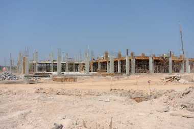 MALACCA, MALAYSIA -JUNE 13, 2016: Construction site in progress at Malacca, Malaysia during daytime. Workers busy with their task such as installing form work and reinforcement bar.     