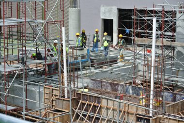 MALACCA, MALAYSIA -JUNE 13, 2016: Construction site in progress at Malacca, Malaysia during daytime. Workers busy with their task such as installing form work and reinforcement bar.     