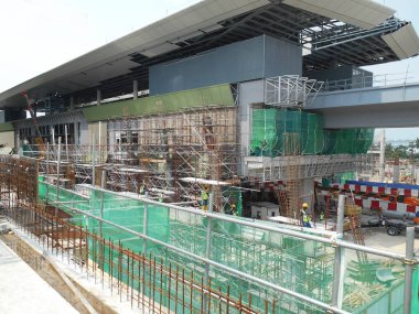 MALACCA, MALAYSIA -JUNE 13, 2016: Construction site in progress at Malacca, Malaysia during daytime. Workers busy with their task such as installing form work and reinforcement bar.     