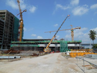 MALACCA, MALAYSIA -JUNE 13, 2016: Construction site in progress at Malacca, Malaysia during daytime. Workers busy with their task such as installing form work and reinforcement bar.     