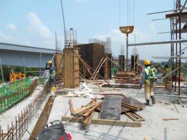 MALACCA, MALAYSIA -MAY 30, 2016: Construction site in progress at MALACCA, Malaysia during daytime. Workers busy with their task such as installing timber form work and reinforcement bar.     