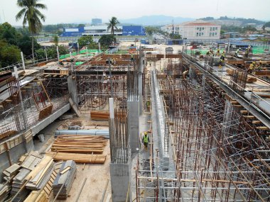 MALACCA, MALAYSIA -MAY 30, 2016: Construction site in progress at MALACCA, Malaysia during daytime. Workers busy with their task such as installing timber form work and reinforcement bar.     