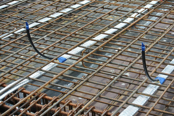 PERAK, MALAYSIA -APRIL 12, 2016: Floor slab reinforcement bar with post tension cable tendon on timber form work at the construction site in Perak, Malaysia