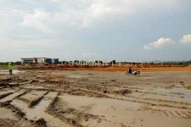 MALACCA, MALAYSIA -MAY 18, 2016: Construction site in progress at Malacca, Malaysia during daytime. Construction machine busy doing the earthwork.      
