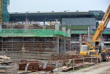 KLANG, MALAYSIA -MAY 13, 2016: Construction workers working at the construction site at Serdang, Malaysia during daytime. They are wearing proper safety gear so ensure they are safe working.  