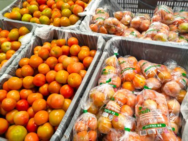 MELAKA, MALAYSIA - JULY 4, 2022: Fresh fruits and vegetables in a supermarket. Some are wrapped in plastic to maintain freshness. Has a price tag and is displayed for sale.