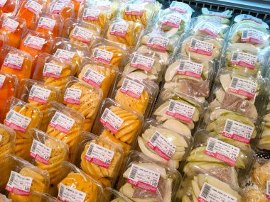 MELAKA, MALAYSIA - JULY 4, 2022: Fresh fruits and vegetables in a supermarket. Some are wrapped in plastic to maintain freshness. Has a price tag and is displayed for sale.