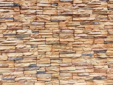 Artificial stone cladding. Designed to resemble real stone. Arranged vertically and attached to the wall with a special adhesive. Used as decoration on the walls of buildings.