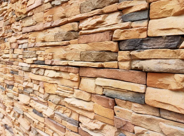 Artificial stone cladding. Designed to resemble real stone. Arranged vertically and attached to the wall with a special adhesive. Used as decoration on the walls of buildings.
