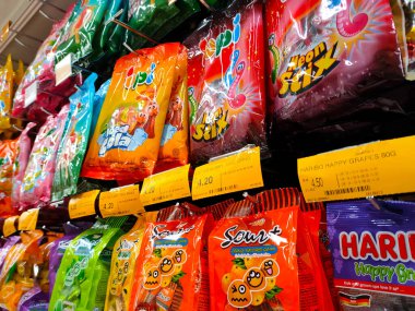 JOHOR, MALAYSIA - 6 Nisan 2022: Orta ölçekli ticari paketler halinde şeker ve şekerler sergilenmek üzere asıldı. Müşterilerin dikkatini çekmek için güzel bir paketin olsun..