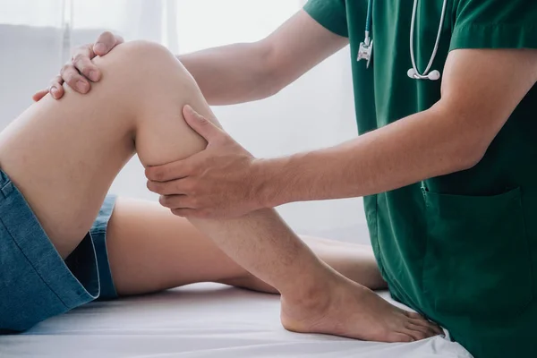 Fiziksel rehabilitasyon kavramı yüzünden uzun süre oturmaktan dolayı uyluk ağrısını tedavi ediyor. Modern kliniklerde yaralı kalça ağrısını tedavi eden bir terapist..