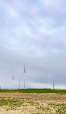 Mavi gökyüzü ve turbo jeneratörle elektrik rüzgar türbini üretiliyor.