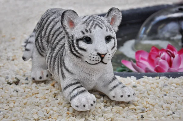 A tiger statuette on gray stones natural floore. Chinese Happy New Year. Tiger is symbol of the year 2022