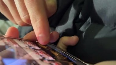 Hand scrolling in the photos gallery on the smartphone 