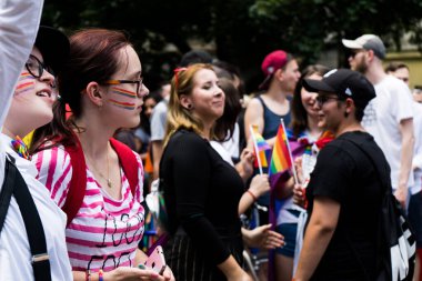 People marching for equal rights for LGBTQ+ community with rainbow flags in Europe