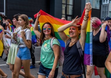Avrupa 'da gökkuşağı bayraklı LGBTQ + topluluğu için eşit haklar için yürüyen insanlar