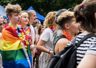 People marching for equal rights for LGBTQ+ community with rainbow flags in Europe