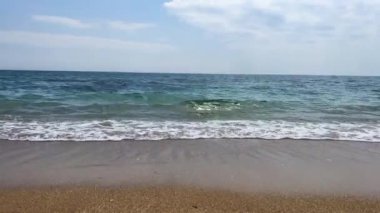 Peaceful seascape of the mediterranean sea with low waves on seashore