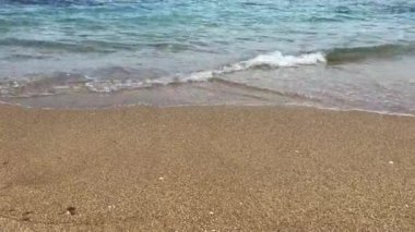 Peaceful view of the mediterranean sea with low waves on seashore