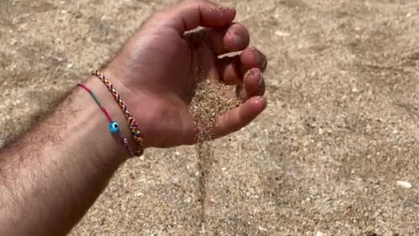 Male Hand Pouring Sand Beach — Stockvideo