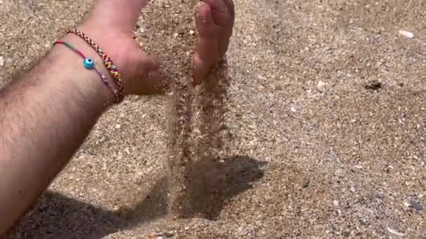 Male Hand Pouring Sand Beach — Stockvideo