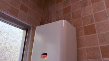 Gas water heater turned on and pumping out black smoke into the air