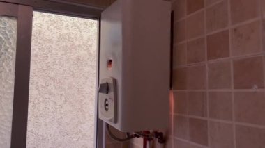 Gas water heater turned on and pumping out black smoke into the air