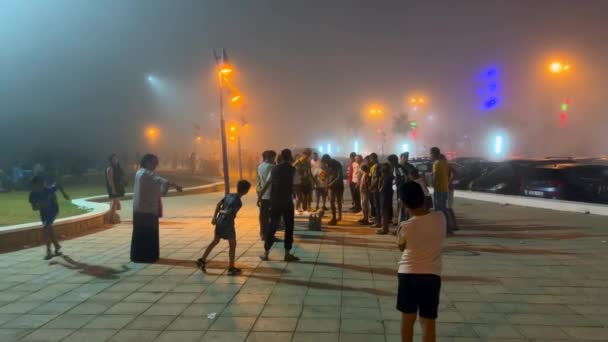 Crowd People Walking Public Square Foggy Night — Stock Video