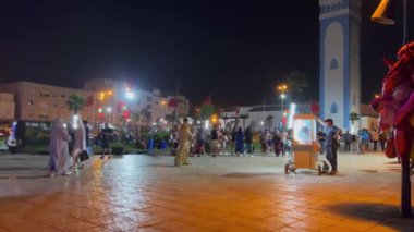 Crowd of people hanging out in a public square