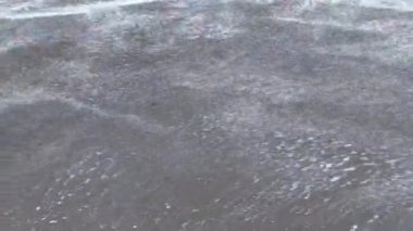 Low angle of the seashore with strong waves near the shore