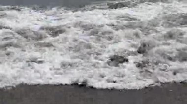 Low angle of the seashore with strong waves near the shore