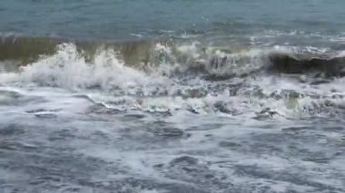 Low angle of the seashore with strong waves near the shore