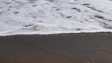 Low angle of the seashore with strong waves near the shore
